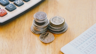 stack-of-money-coin-on-woo-office-desk-with-bank-b-2023-02-22-00-26-03-utc